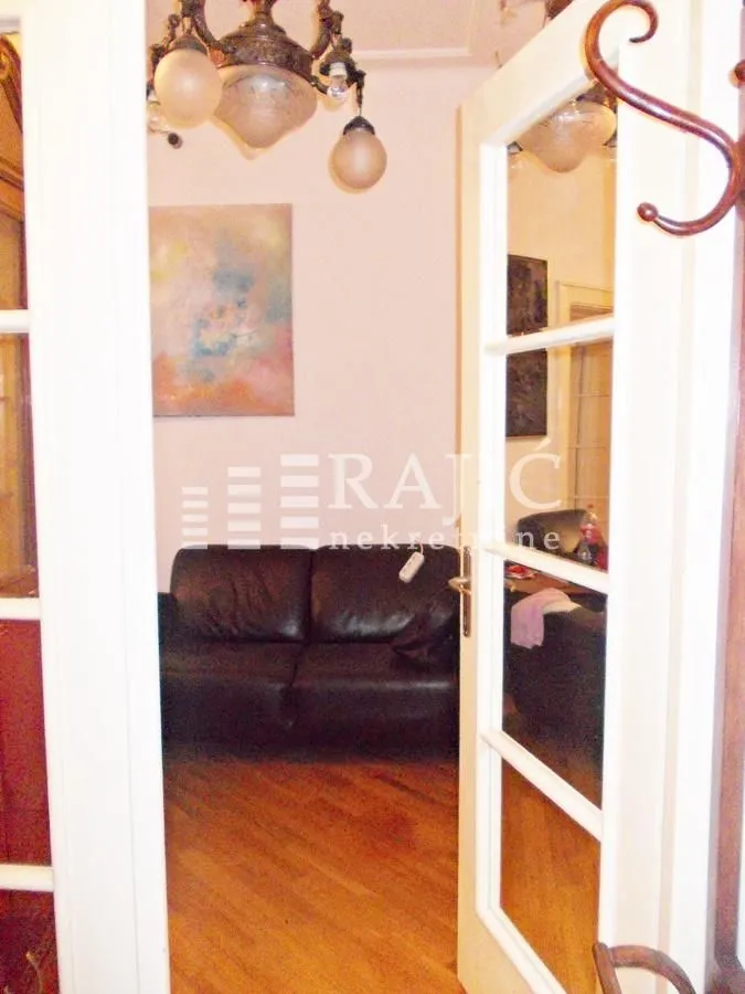 View through the door into the living room with a sofa.