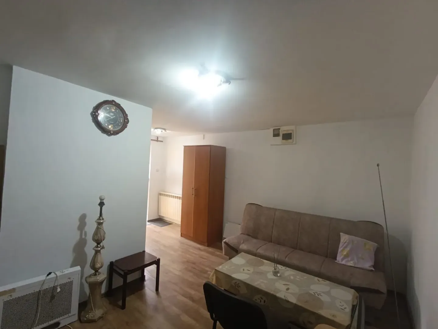 Living room with a sofa, coffee table, and wardrobe.