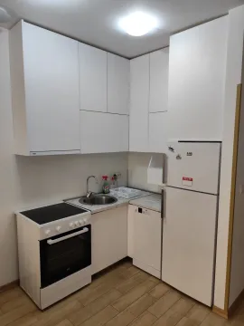 White kitchen with built-in kitchen units, stove and refrigerator. - image 2