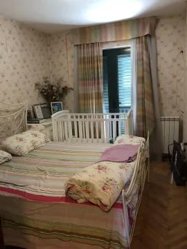 A bedroom with a double bed and a baby crib. - image 19