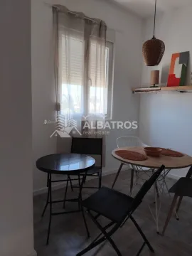 Small dining area with a table and chairs by the window. - image 3