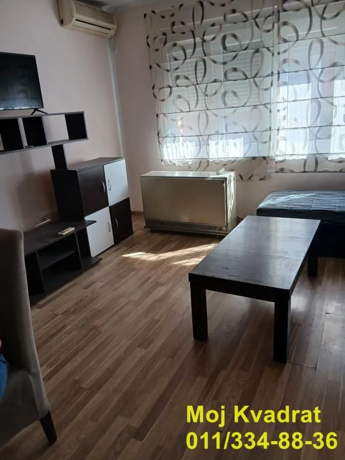 Living room with furniture, coffee table and TV unit.