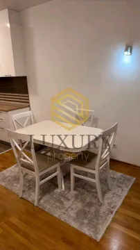 Dining area with a white table and four chairs as part of the kitchen. - image 2