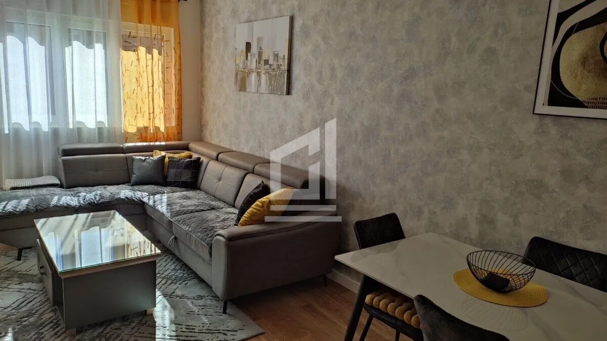 Living room with a sectional sofa, coffee table, and dining table.