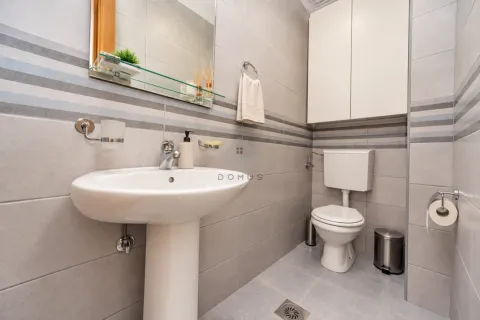 Small bathroom with a washbasin, toilet, and wall cabinet. - image 25