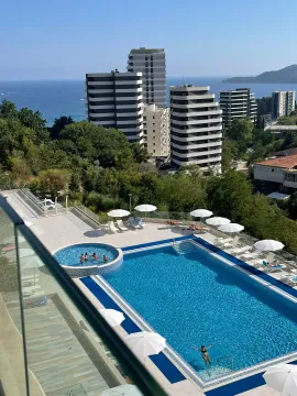 View from the terrace of the swimming pool and modern buildings near the sea. - image 8