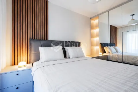 Modern bedroom with a double bed, wooden wall panels, and a large built-in mirrored wardrobe. - image 6