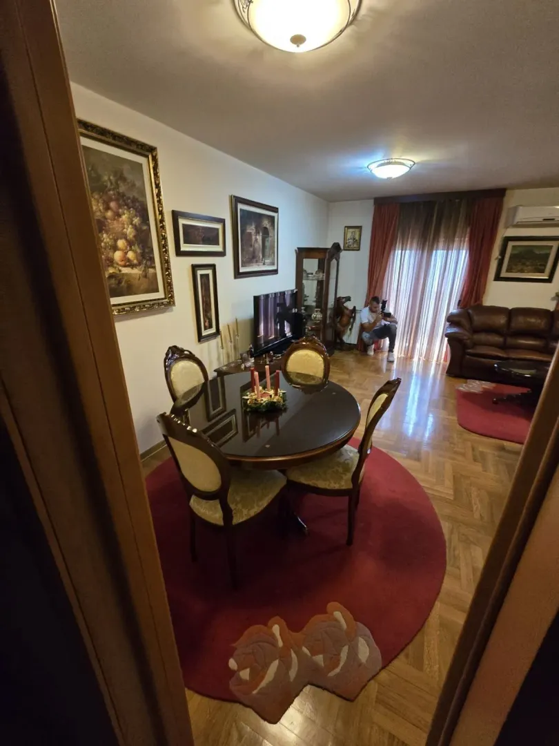 Dining area with a round table and chairs connected to the living room.