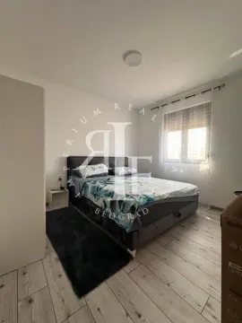 Furnished bedroom with a double bed, wardrobe, and a window. - image 30
