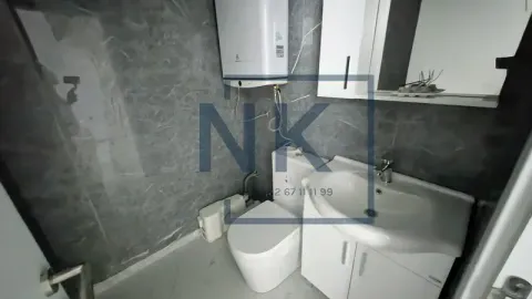 View of a modern bathroom equipped with a sink and toilet. - image 15