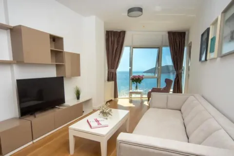 Bright living room with a sofa, TV unit, and a sea view. - image 6