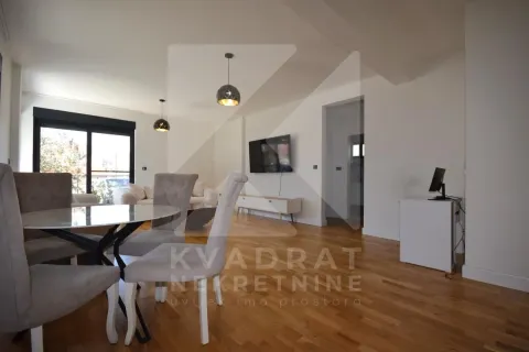 Living room with dining area and hardwood flooring. - image 4