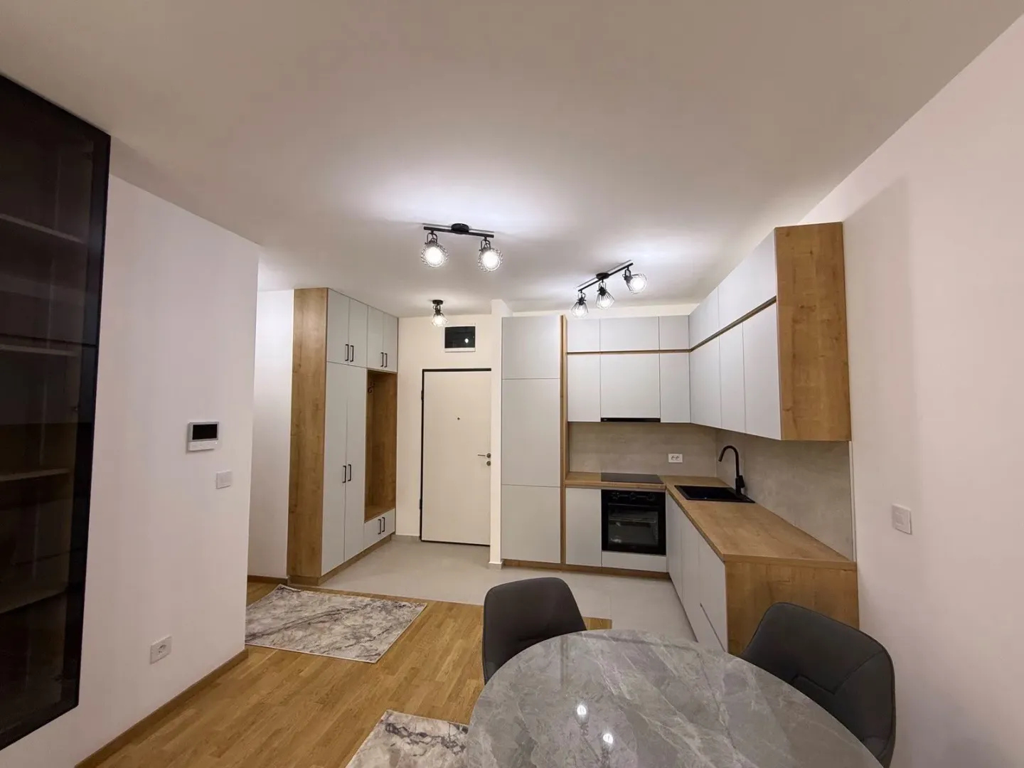 Modern kitchen with built-in cabinetry and a dining table.