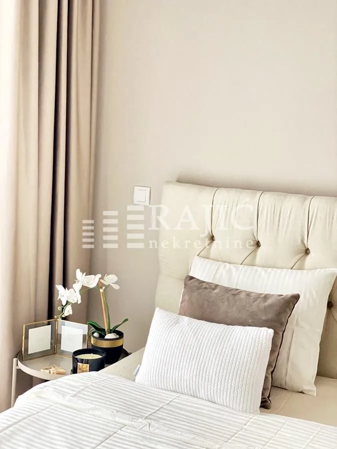 Decorated bedroom with a double bed and decorative pillows.