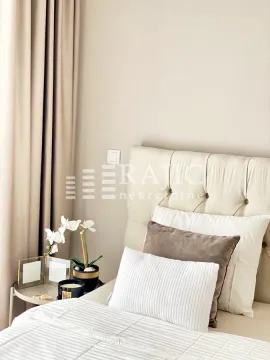 Decorated bedroom with a double bed and decorative pillows. - image 10
