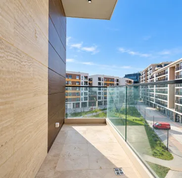 Modern spacious balcony with a view of surrounding buildings and courtyard. - image 3