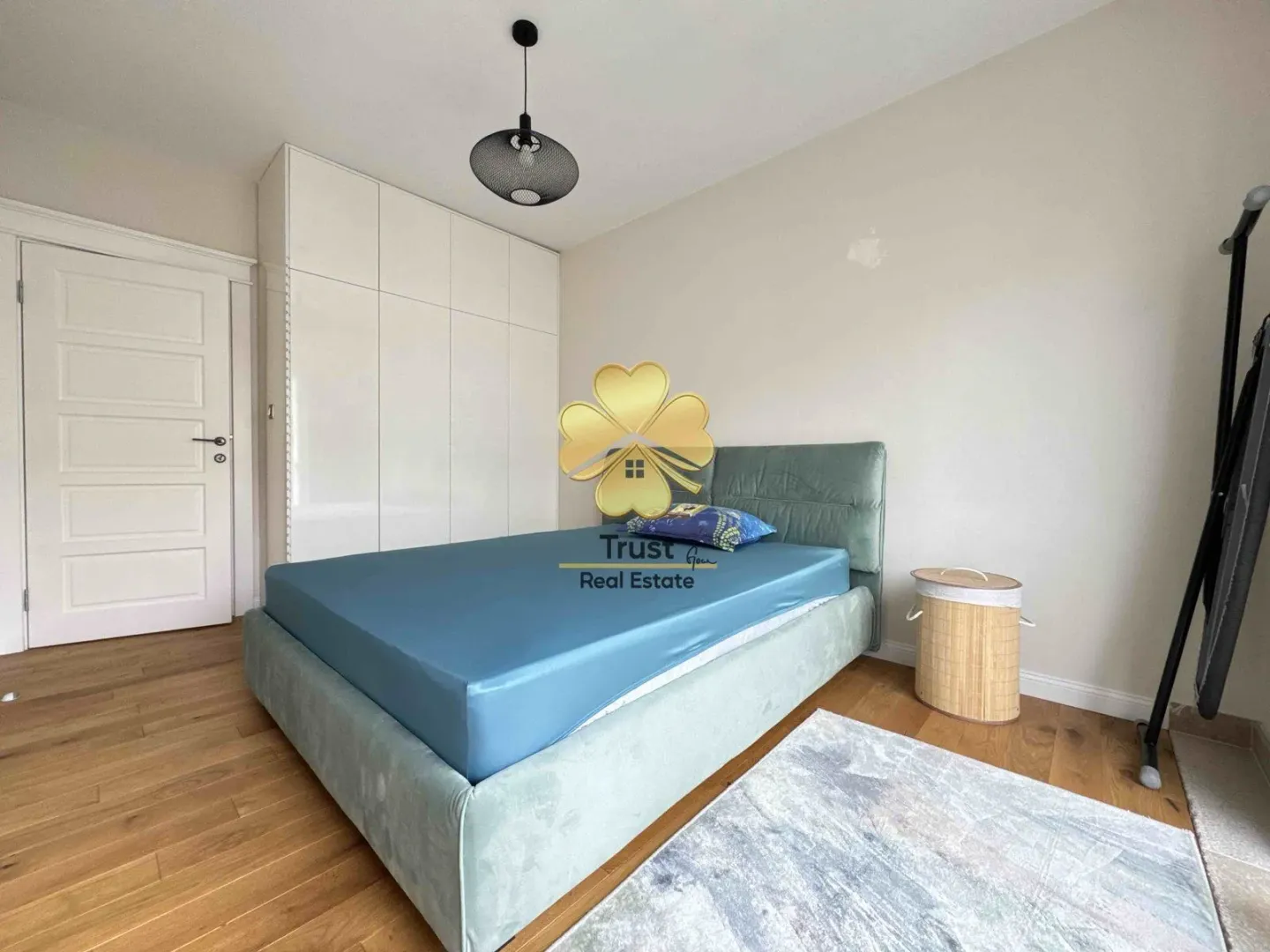 Furnished bedroom with a double bed and built-in wardrobe.