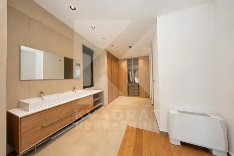 Spacious bathroom with double vanity and built-in closets. - image 7