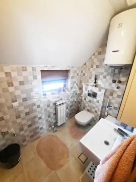 Compact bathroom with sanitary fixtures, shower, and water heater in the attic. - image 9