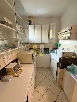 Small kitchen with white cabinets and shelving. - image 4