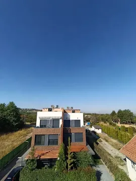 View of the exterior of a modern residential building with a yard. - image 29