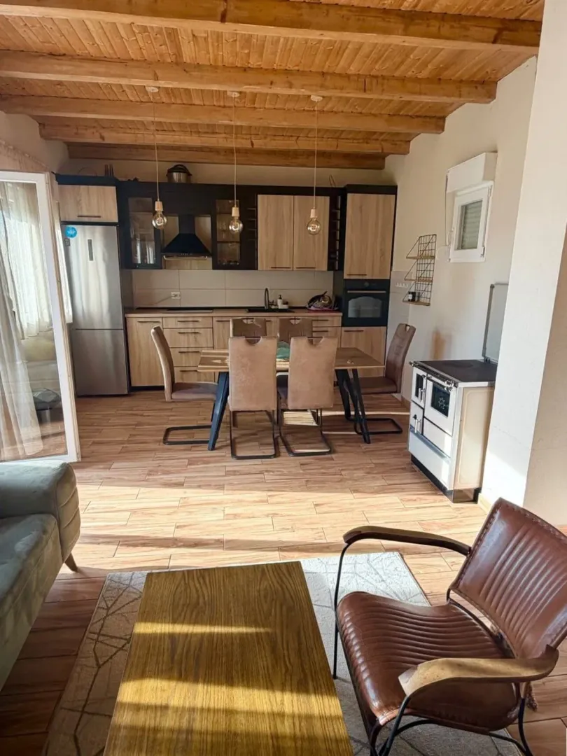 Living room with dining area and kitchen in an open space layout.