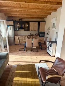 Living room with dining area and kitchen in an open space layout. - image 4
