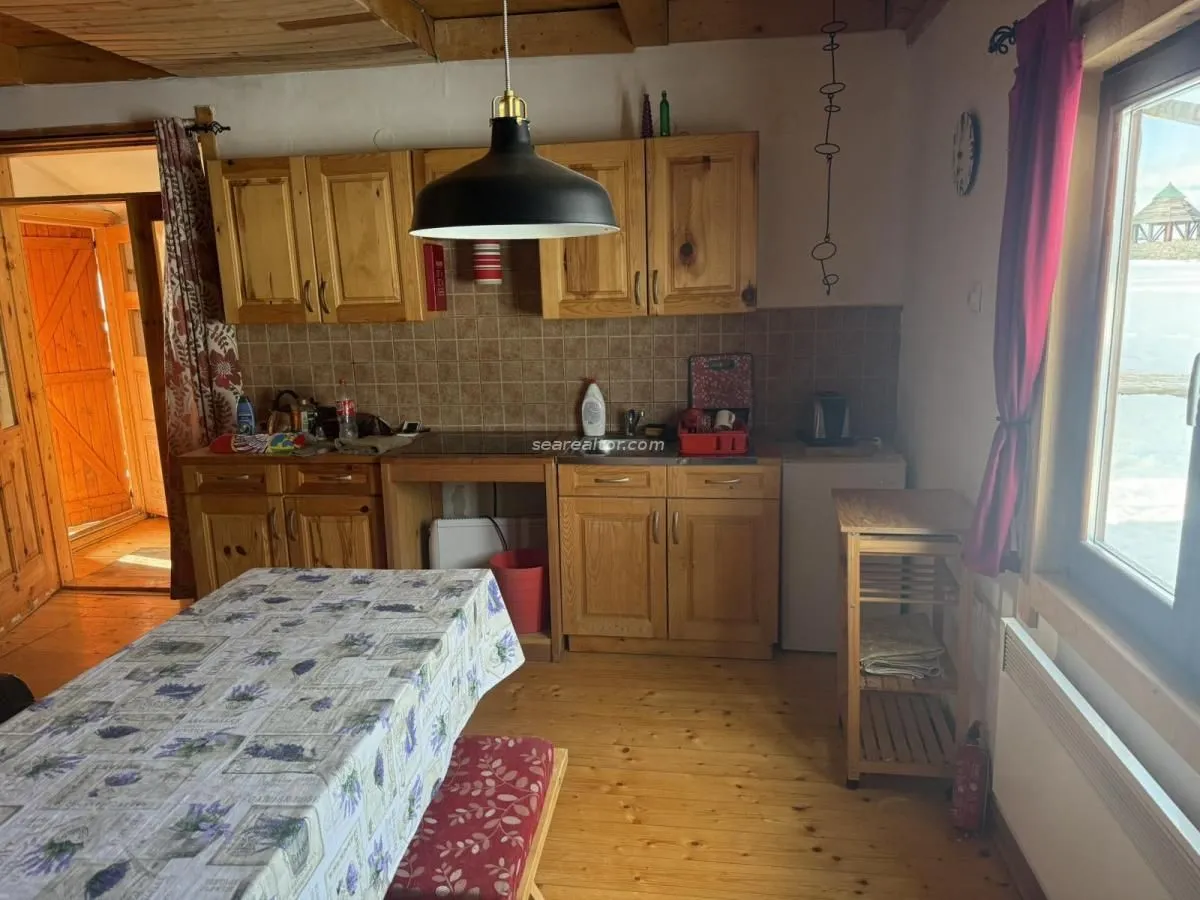 Kitchen with wooden cabinetry and a dining table.