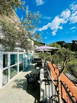 Spacious terrace with outdoor seating and surrounding view. - image 4