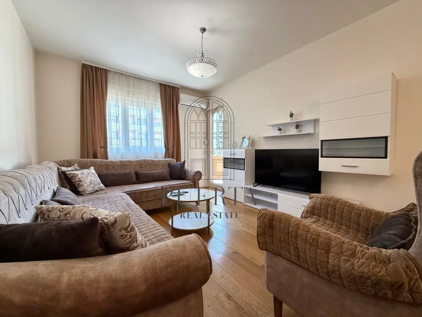 Comfortable living room with sofa set and TV.