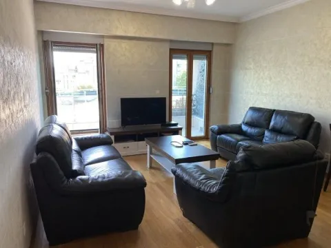 Living room with leather sofas, a coffee table, and a TV. - image 3