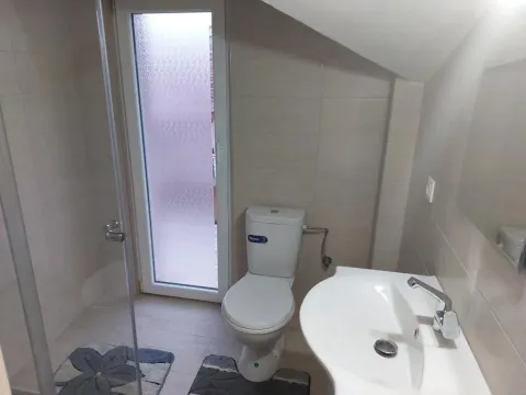 Bathroom equipped with sanitary fixtures, a shower cabin, and a door leading to the terrace. - image 21