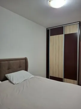 Bedroom with a bed and a large built-in wardrobe. - image 3