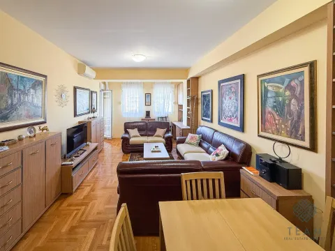 Spacious living room with seating furniture and a dining table. - image 2