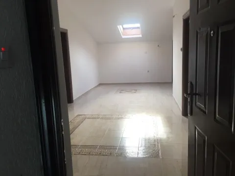 Empty attic room with a skylight and tiled floor. - image 6