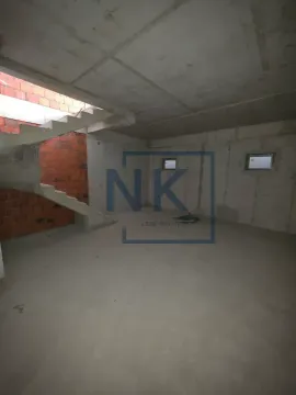 Unfinished interior space in a rough construction phase with a staircase. - image 9