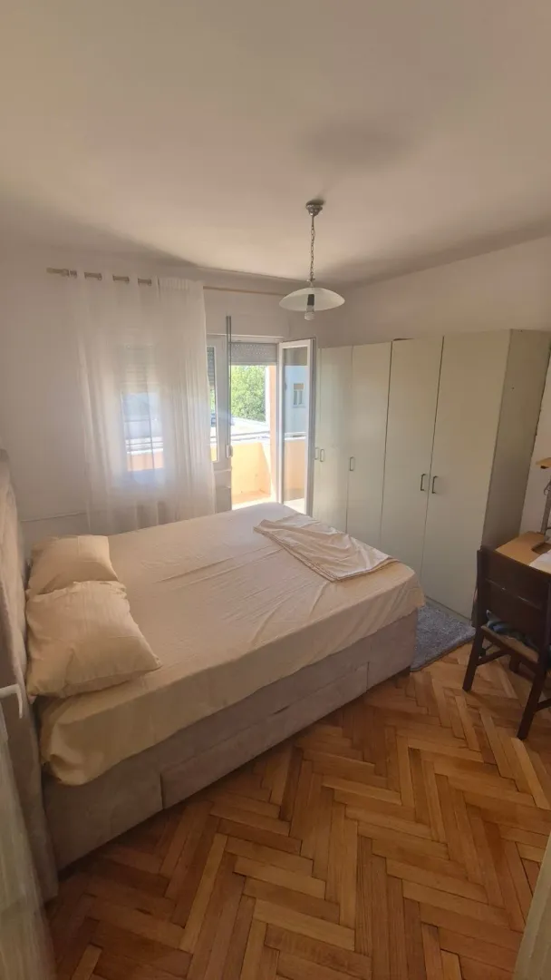 Bedroom with a double bed, wardrobe, and access to the terrace.