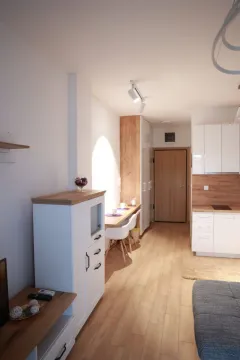 View of the kitchen with white cabinetry and a dining area. - image 22