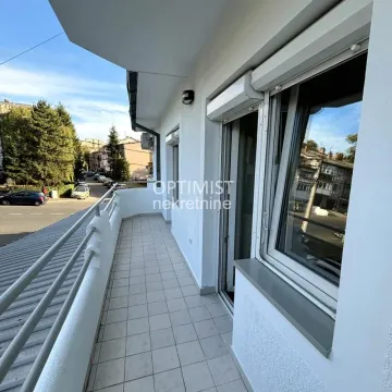 Dugačak popločani balkon sa metalnom ogradom i pogledom na ulicu. - image 13