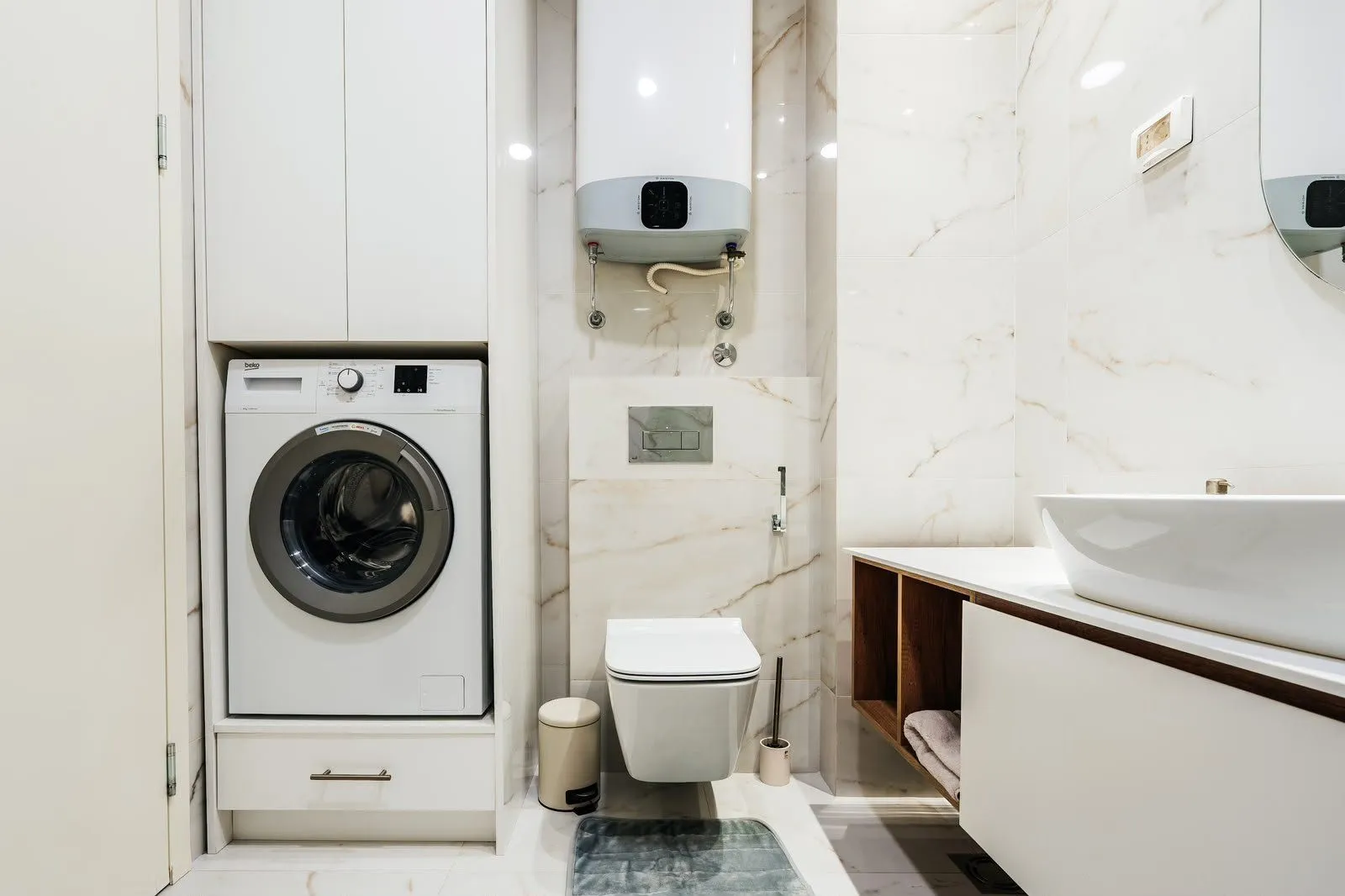 Modern bathroom equipped with a built-in washing machine and water heater.