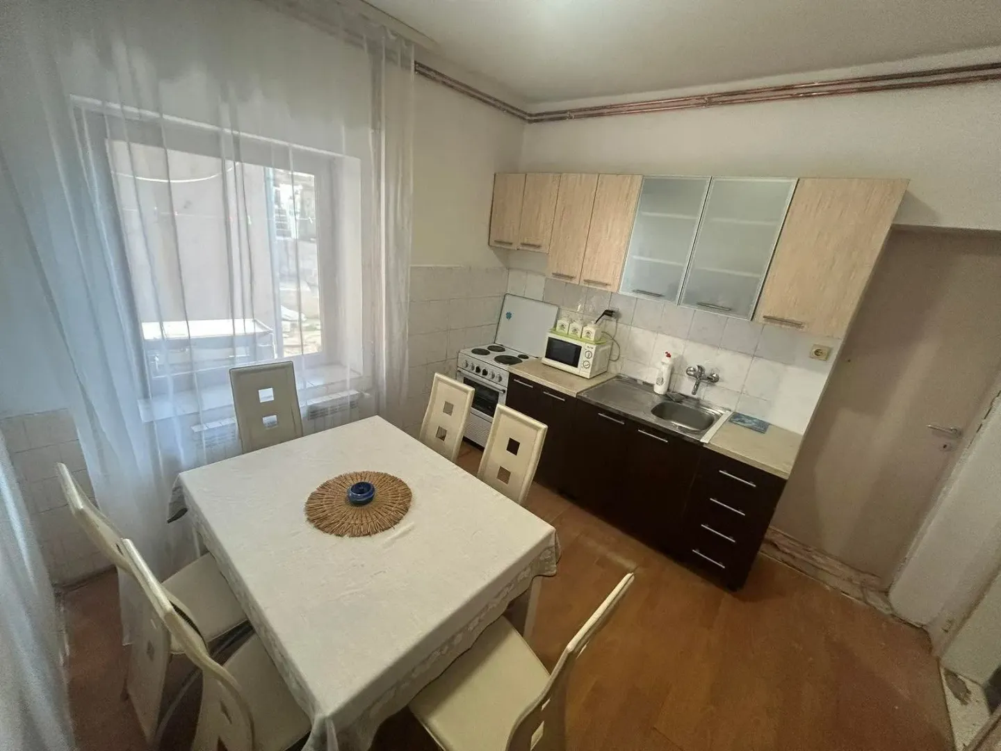 Smaller kitchen with a dining table and window.