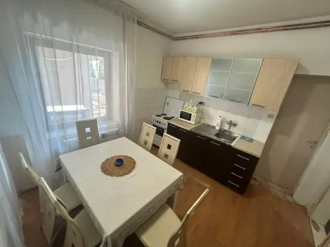 Smaller kitchen with a dining table and window. - image 4