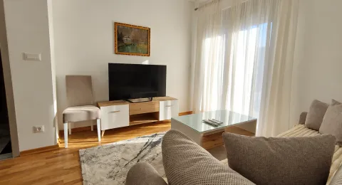 Living room with sofa set, TV stand and large window. - image 9