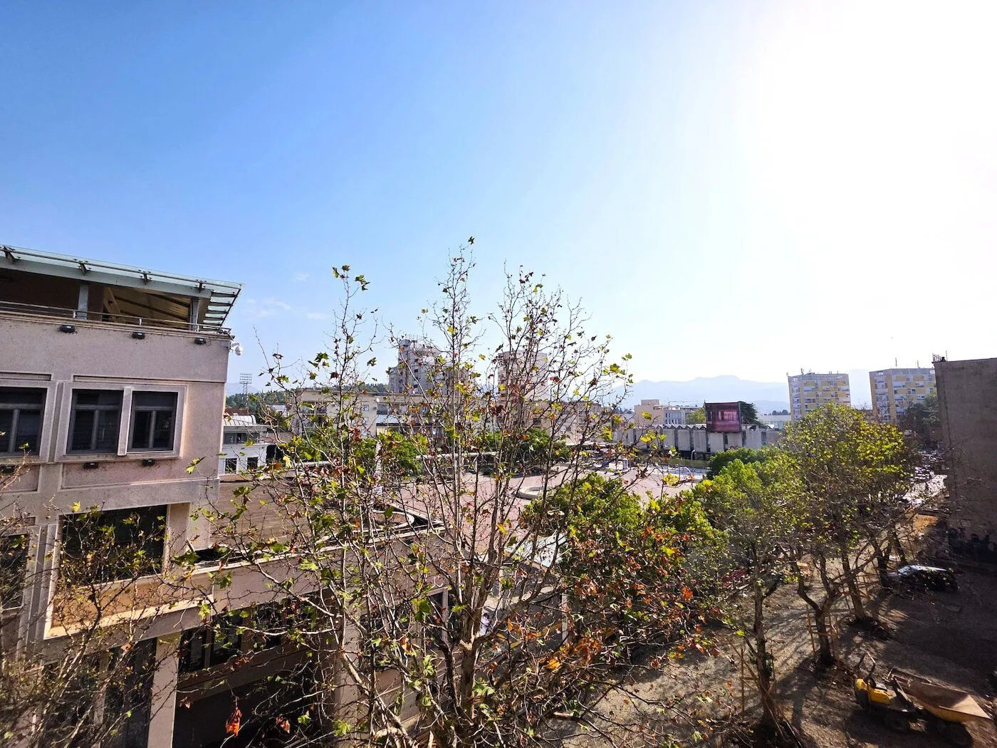 View from the window of surrounding buildings and trees.