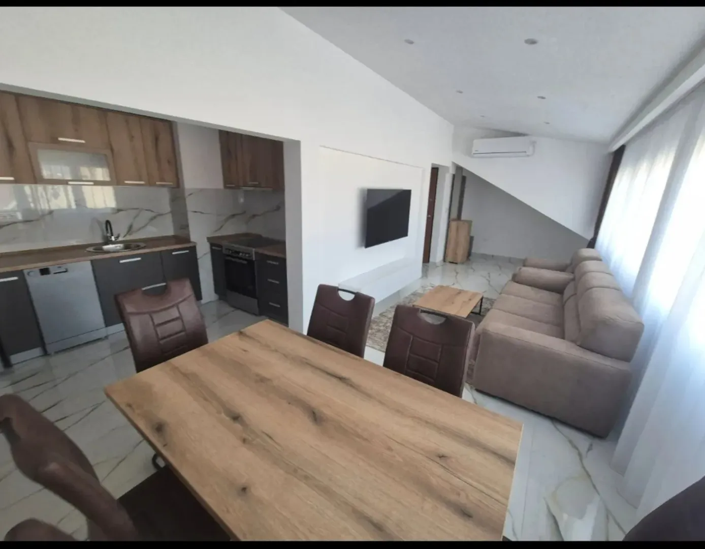 Living room with dining area and open-plan kitchen.