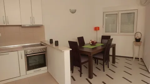 Modern kitchen with dining area and white cabinetry. - image 3