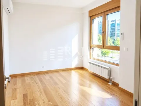 Empty room with wooden flooring and a window. - image 4
