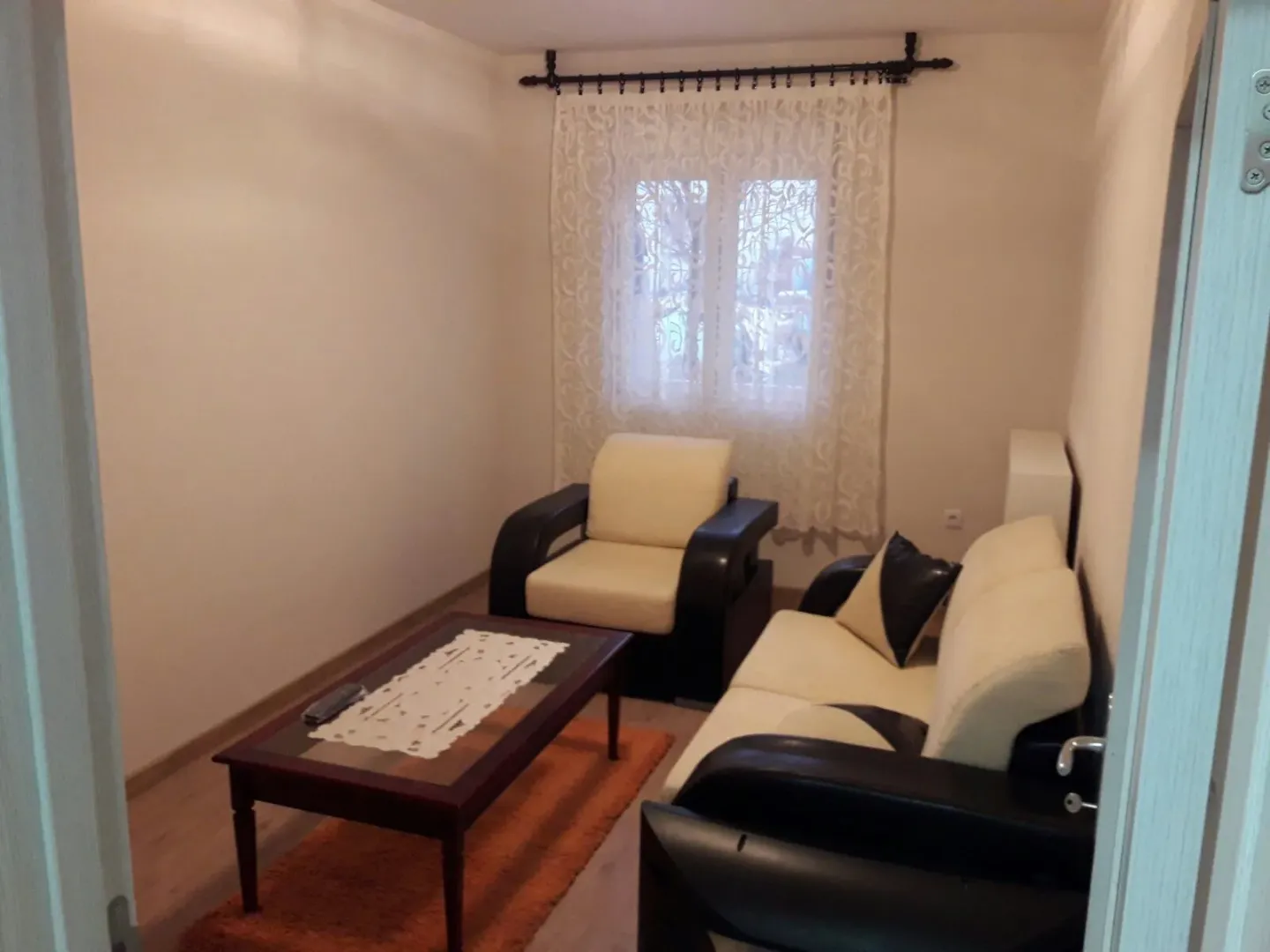 A simple living room with a seating set and a coffee table.