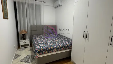 Furnished bedroom with a double bed and a large white wardrobe. - image 9