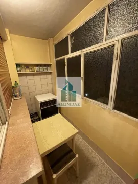 Smaller kitchen with a dining table and windows. - image 7
